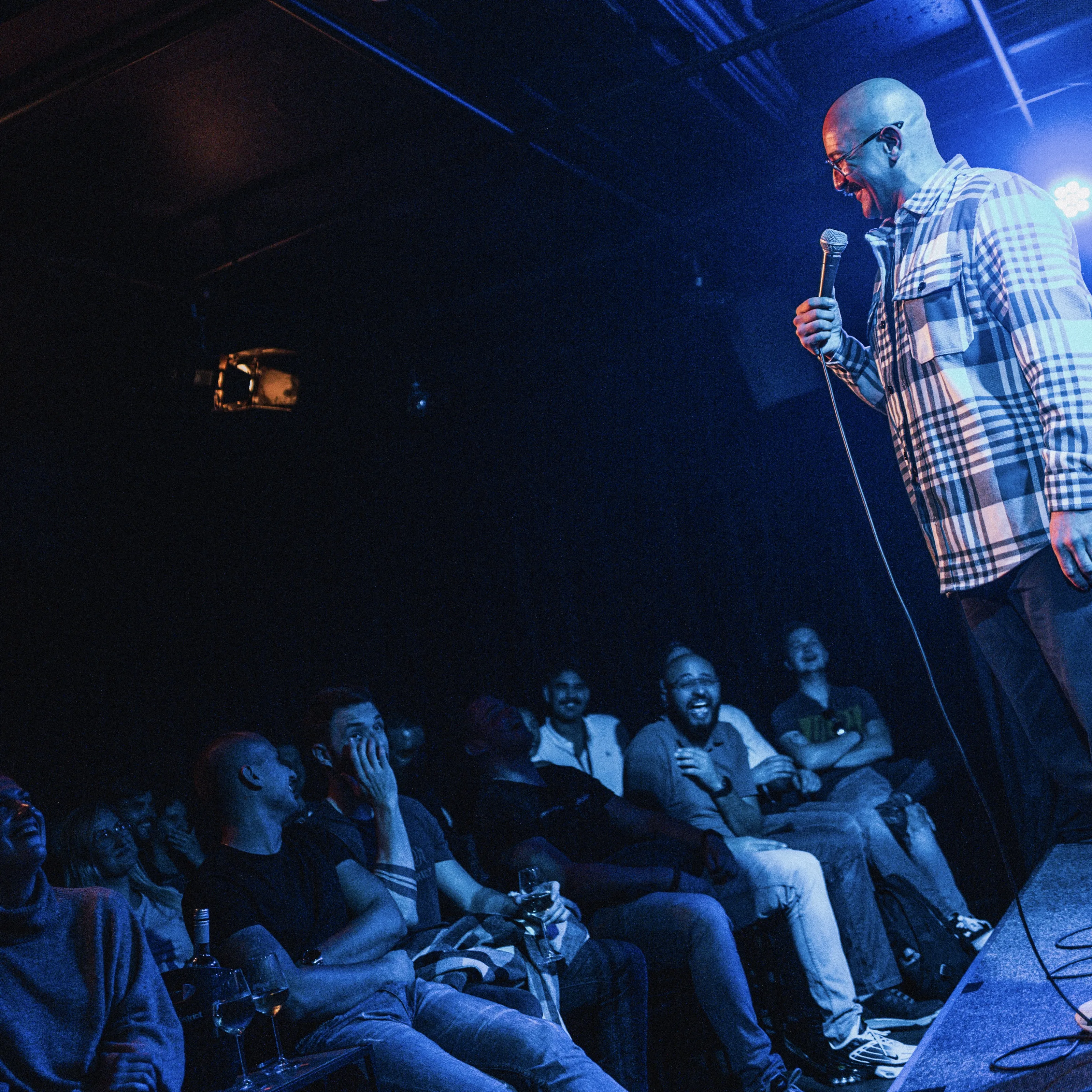Image showing faces of comedians, and information about the comedy show