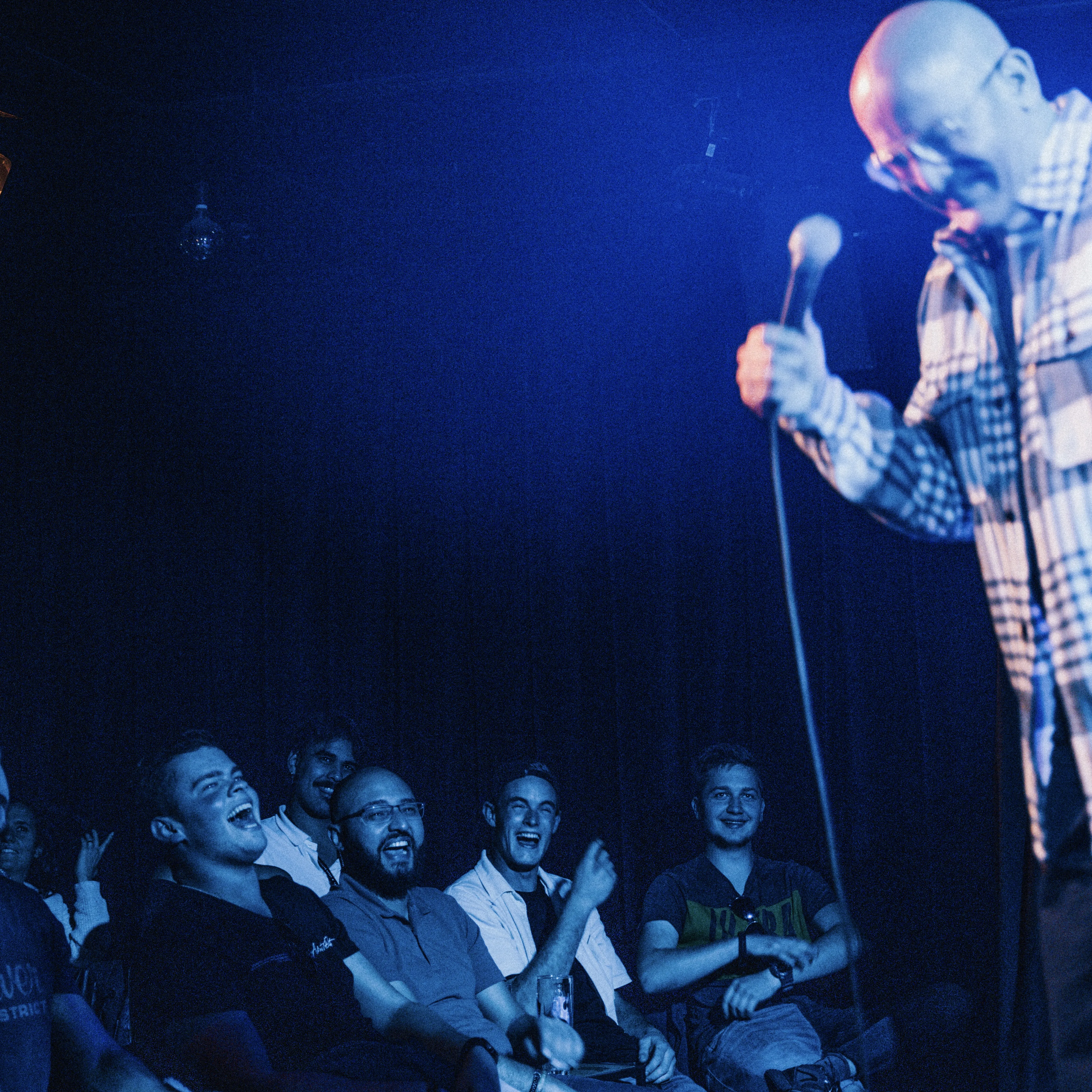 Image showing faces of comedians, and information about the comedy show