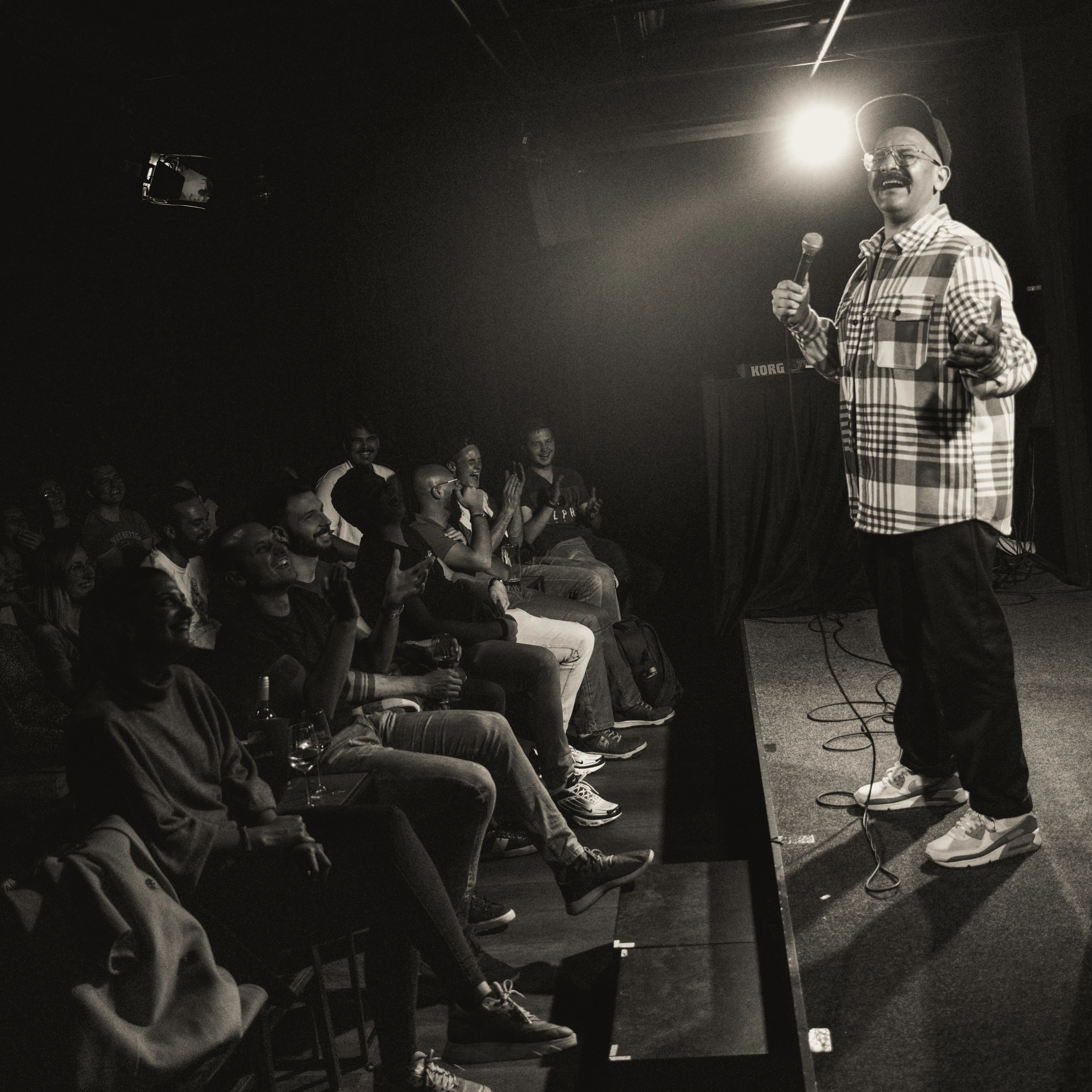 Image showing faces of comedians, and information about the comedy show